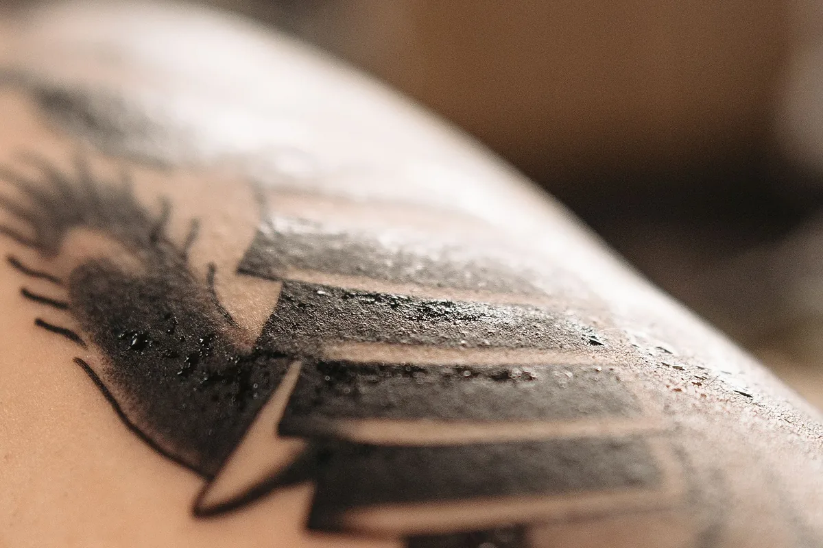 Close-up of a freshly finished black tattoo at the start of tattoo healing