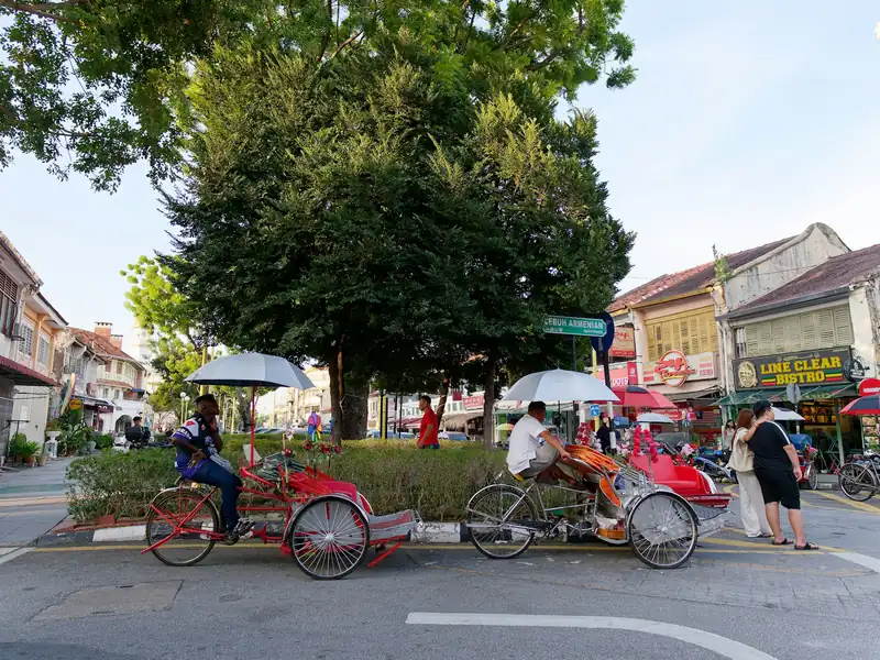 Trishaws parked by heritage shophouses in George Town, Penang