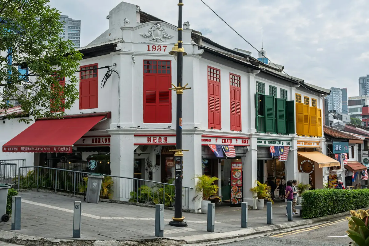 Colourful heritage shophouses with shuttered windows, the kind of street where a tattoo shop in Penang often operates