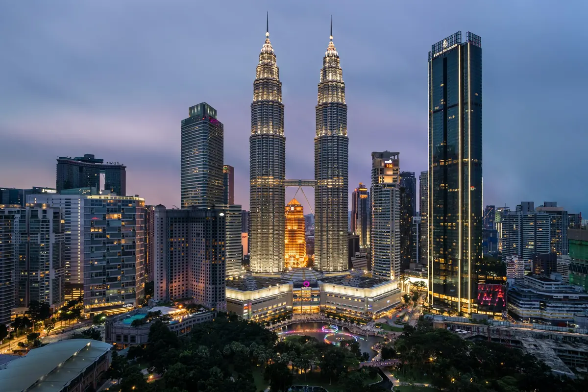 Kuala Lumpur skyline with the Petronas Twin Towers at dusk, home to many a tattoo shop in KL