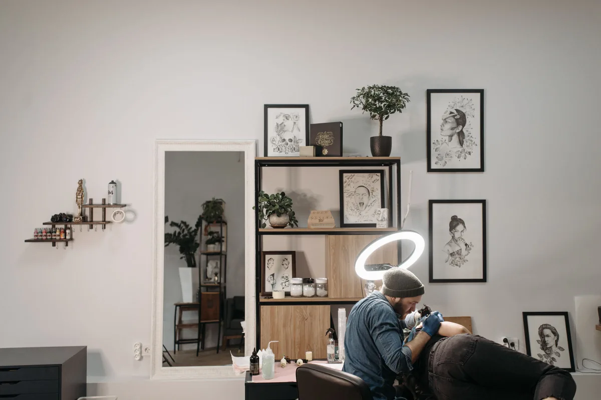 Tattoo artist working in a bright, tidy studio, the kind of work Tattoo Malaysia writes about